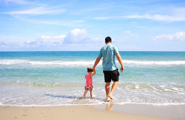 πατέρας με κόρη περπατούν στη θάλασσα
